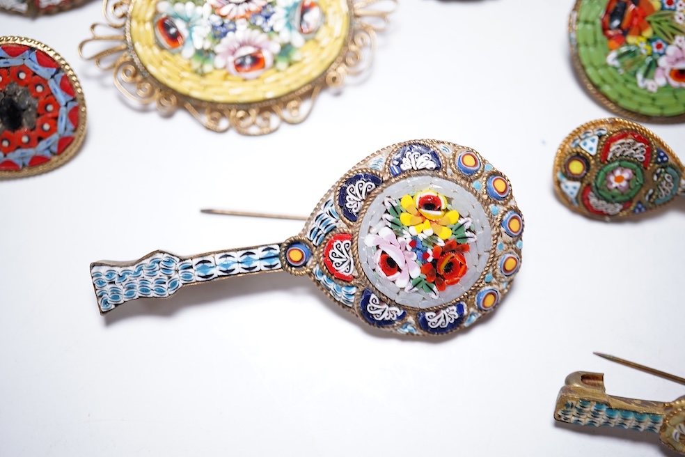 A collection of twenty-five micro-mosaic costume jewellery brooches. Including thirteen banjo and guitars shaped brooches, six large oval and circular brooches and six smaller brooches. Condition - mostly good